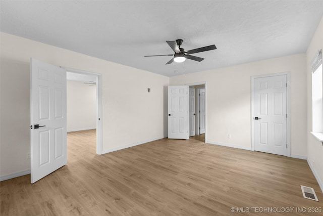 524 W 18th, Ada, OK 74820 - unfurnished bedroom with light wood finished floors, baseboards, and ceiling fan