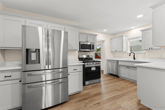 524 W 18th, Ada, OK 74820 - kitchen featuring appliances with stainless steel finishes, a sink, light countertops, and recessed lighting