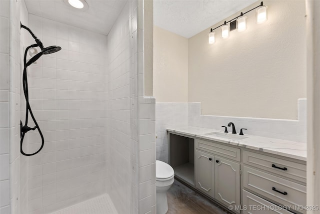 524 W 18th, Ada, OK 74820 - full bath with tiled shower, vanity, toilet, and wainscoting