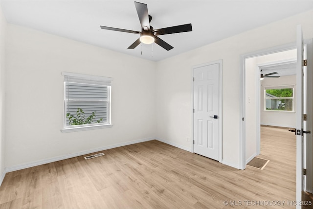 524 W 18th, Ada, OK 74820 - unfurnished bedroom featuring light wood-style floors, baseboards, and a ceiling fan