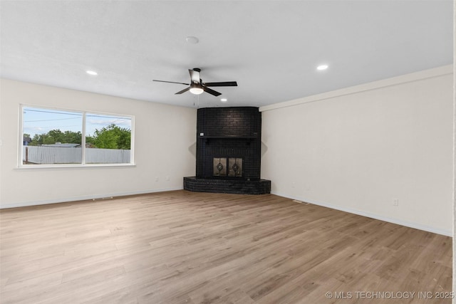 524 W 18th, Ada, OK 74820 - unfurnished living room featuring a ceiling fan, wood finished floors, a brick fireplace, recessed lighting, and baseboards