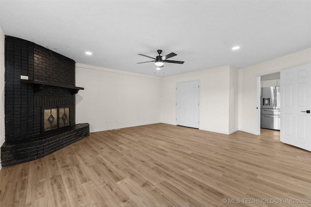 524 W 18th, Ada, OK 74820 - unfurnished living room featuring a ceiling fan, baseboards, light wood finished floors, recessed lighting, and a brick fireplace