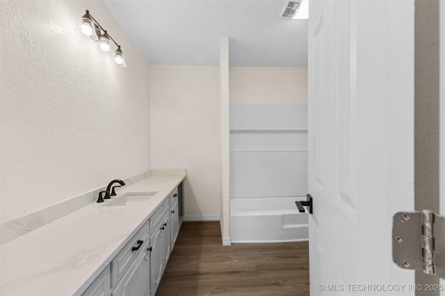 524 W 18th, Ada, OK 74820 - full bath featuring vanity, wood finished floors, a tub, and baseboards