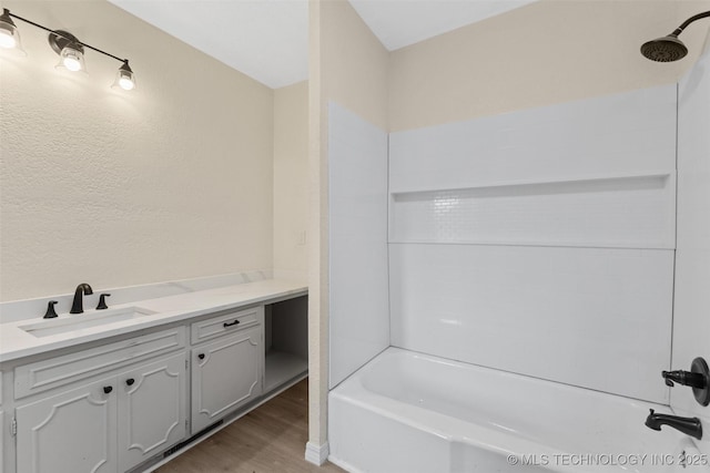 524 W 18th, Ada, OK 74820 - full bath featuring wood finished floors,  shower combination, and vanity