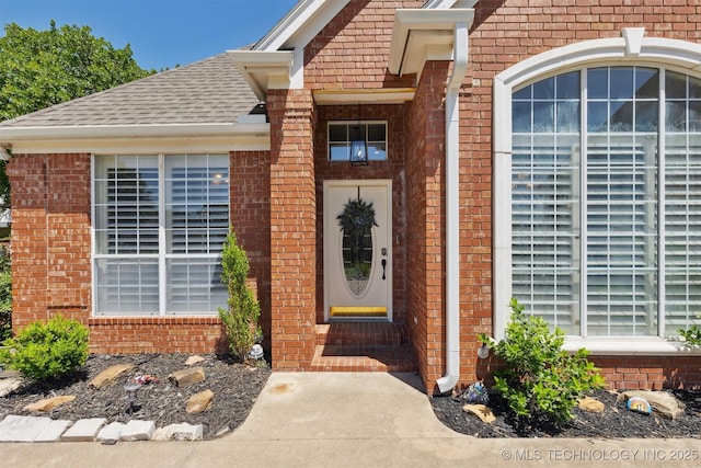 1631 Augusta, Ada, OK 74820 - doorway to property with brick siding and roof with shingles