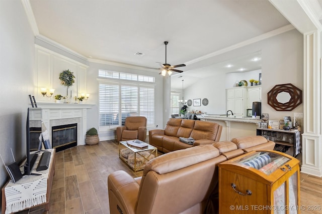 1631 Augusta, Ada, OK 74820 - living room featuring ceiling fan, light wood finished floors, a fireplace, ornamental molding, and recessed lighting