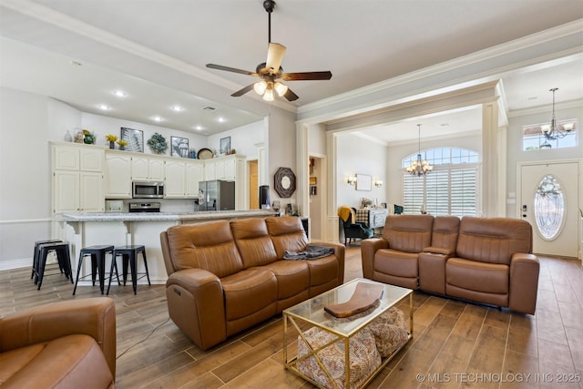 1631 Augusta, Ada, OK 74820 - living area featuring a chandelier, ornamental molding, wood tiled floors, a ceiling fan, and recessed lighting