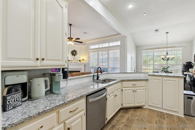 1631 Augusta, Ada, OK 74820 - kitchen with dishwasher, a sink, a fireplace, ceiling fan, and a chandelier