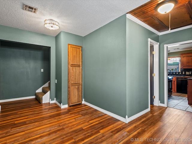 324 2019th Rd, Bartlesville, OK 74003 - unfurnished bedroom with wood finished floors, attic access, baseboards, and ornamental molding