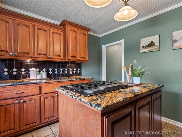 324 2019th Rd, Bartlesville, OK 74003 - kitchen featuring light tile patterned flooring, tasteful backsplash, gas stovetop, dark stone countertops, and ornamental molding