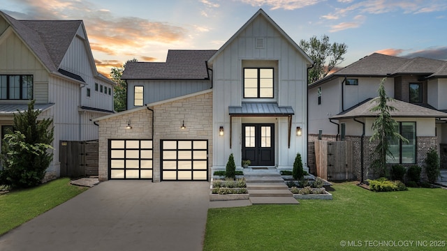 1038 E 38th Pl, Tulsa, OK 74105 - modern farmhouse style home with concrete driveway, an attached garage, board and batten siding, a gate, and a standing seam roof