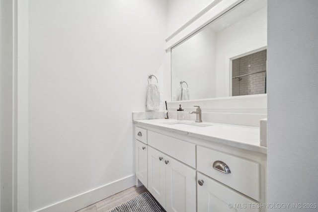 1038 E 38th Pl, Tulsa, OK 74105 - bathroom featuring vanity, wood finished floors, a shower, and baseboards