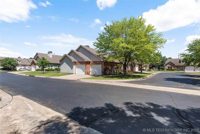 7724 S 83rd E Ave, Tulsa, OK 74133 - view of front of house with a garage, a residential view, driveway, and brick siding