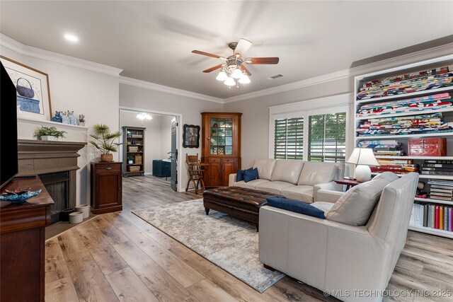 7724 S 83rd E Ave, Tulsa, OK 74133 - living area featuring a ceiling fan, light wood-style flooring, crown molding, and a fireplace