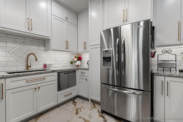 7724 S 83rd E Ave, Tulsa, OK 74133 - kitchen featuring stainless steel refrigerator with ice dispenser, light marble finish flooring, a sink, dishwasher, and decorative backsplash