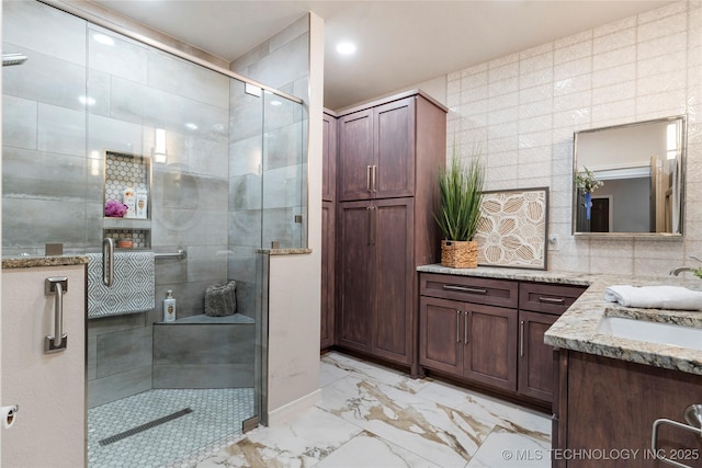 7724 S 83rd E Ave, Tulsa, OK 74133 - bathroom with marble finish floors, vanity, a stall shower, tile walls, and recessed lighting