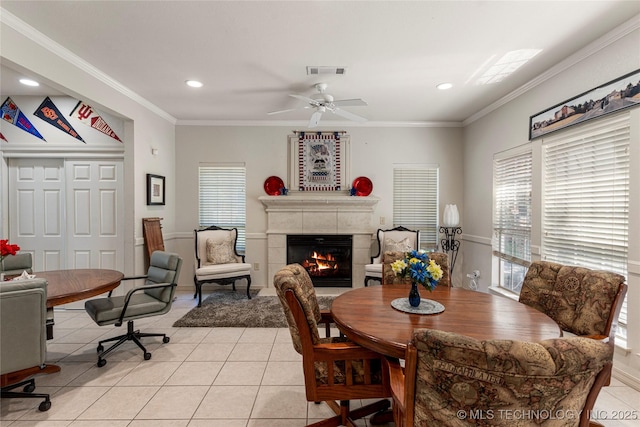 7724 S 83rd E Ave, Tulsa, OK 74133 - dining room featuring light tile patterned flooring, a tile fireplace, healthy amount of natural light, crown molding, and recessed lighting
