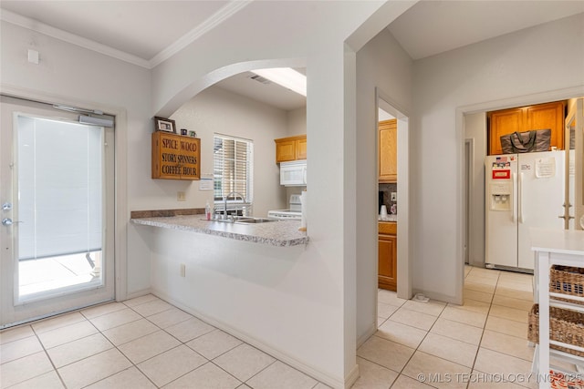 7724 S 83rd E Ave, Tulsa, OK 74133 - kitchen with white appliances, light tile patterned floors, arched walkways, light countertops, and crown molding