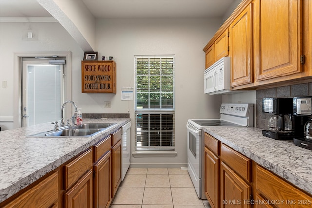7724 S 83rd E Ave, Tulsa, OK 74133 - kitchen featuring white appliances, a sink, brown cabinetry, light tile patterned floors, and light countertops