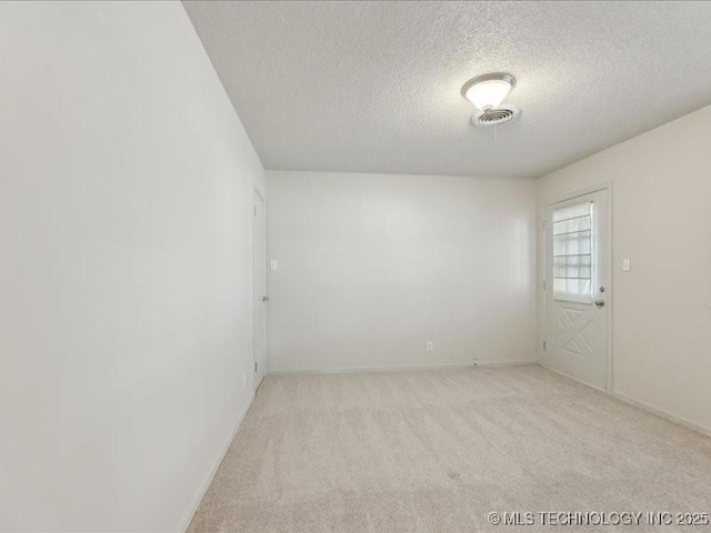5339 S 32nd W Ave, Tulsa, OK 74107 - unfurnished room with a textured ceiling, light carpet, and baseboards