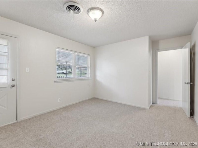 5339 S 32nd W Ave, Tulsa, OK 74107 - empty room featuring light colored carpet, a textured ceiling, and baseboards