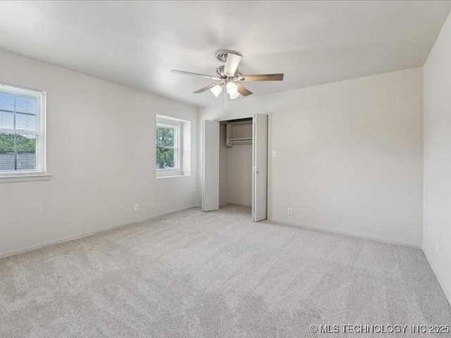 5339 S 32nd W Ave, Tulsa, OK 74107 - unfurnished bedroom with carpet floors, a closet, a ceiling fan, and baseboards