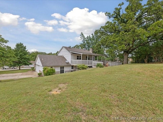 5339 S 32nd W Ave, Tulsa, OK 74107 - view of front facade with a chimney, concrete driveway, a front lawn, a porch, and a garage
