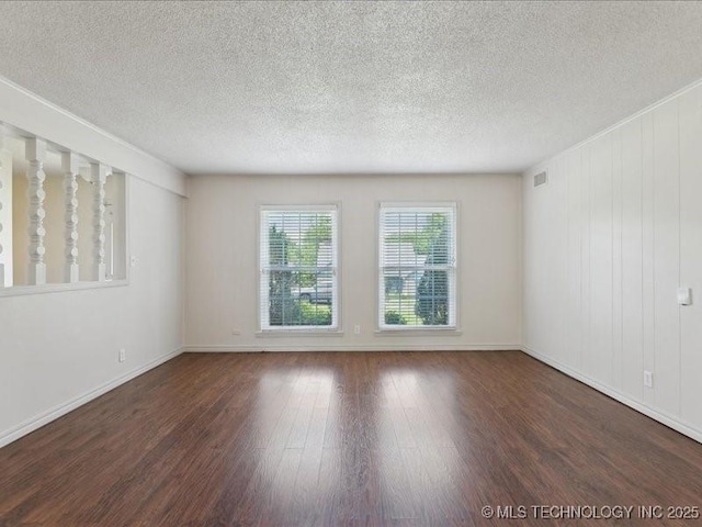 5339 S 32nd W Ave, Tulsa, OK 74107 - empty room with wood finished floors, a textured ceiling, and baseboards