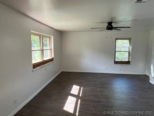 1800 N 26th St, Broken Arrow, OK 74014 - unfurnished room with plenty of natural light, dark wood finished floors, and baseboards
