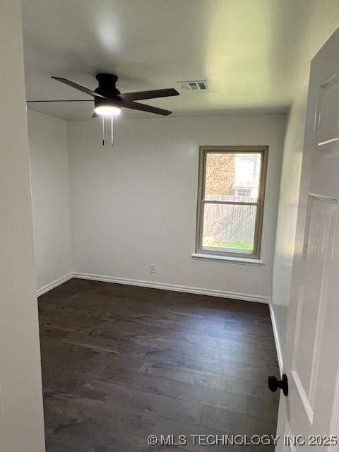 1800 N 26th St, Broken Arrow, OK 74014 - empty room featuring a ceiling fan, dark wood-style flooring, and baseboards
