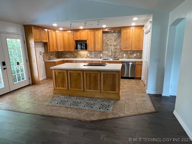 1800 N 26th St, Broken Arrow, OK 74014 - kitchen featuring black appliances, light countertops, light wood-type flooring, decorative backsplash, and recessed lighting