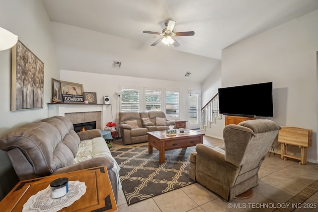 11210 N 131st E Pl, Owasso, OK 74055 - living room featuring a ceiling fan, tile patterned floors, a fireplace, stairway, and high vaulted ceiling