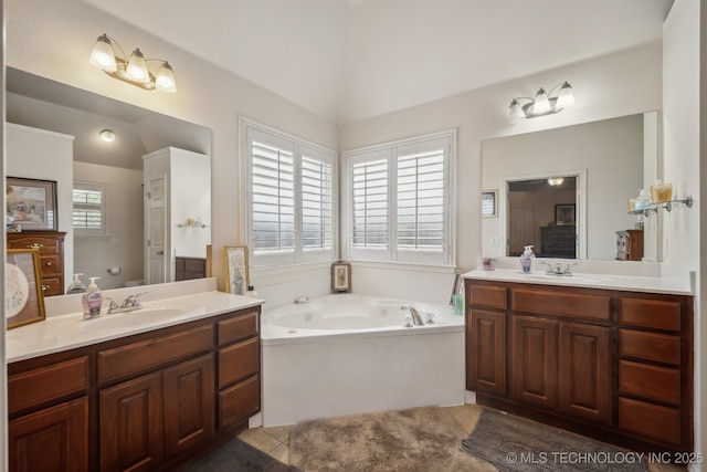 11210 N 131st E Pl, Owasso, OK 74055 - full bathroom featuring two vanities, a garden tub, lofted ceiling, and tile patterned floors