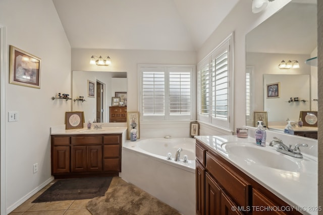 11210 N 131st E Pl, Owasso, OK 74055 - bathroom featuring lofted ceiling, two vanities, a garden tub, and tile patterned flooring