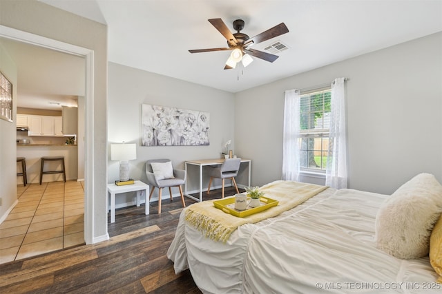 5144 S 34th W Ave, Tulsa, OK 74107 - bedroom with wood finished floors, ceiling fan, and baseboards