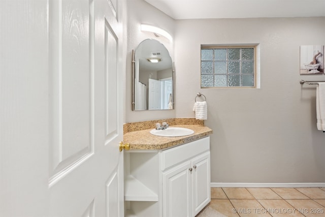 5144 S 34th W Ave, Tulsa, OK 74107 - bathroom featuring vanity, tile patterned flooring, and baseboards