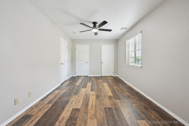 5144 S 34th W Ave, Tulsa, OK 74107 - unfurnished bedroom featuring baseboards, dark wood finished floors, and a ceiling fan