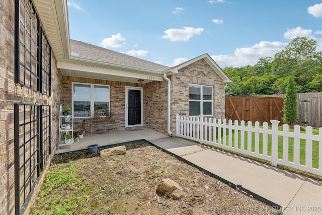 1309 W Missouri Ave, Claremore, OK 74019 - view of front of home featuring a patio, brick siding, and roof with shingles