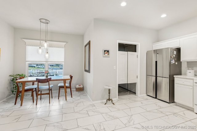 1309 W Missouri Ave, Claremore, OK 74019 - kitchen featuring freestanding refrigerator, light marble finish flooring, white cabinetry, recessed lighting, and light countertops