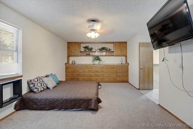 211 Meadowlark, Durant, OK 74701 - bedroom featuring light colored carpet, a textured ceiling, and baseboards