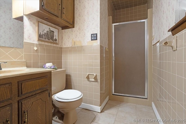 211 Meadowlark, Durant, OK 74701 - bathroom with wallpapered walls, tile walls, a shower stall, vanity, and toilet