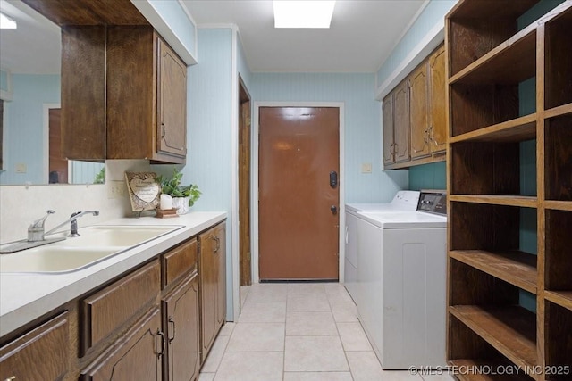 211 Meadowlark, Durant, OK 74701 - laundry area featuring cabinet space, independent washer and dryer, and light tile patterned floors
