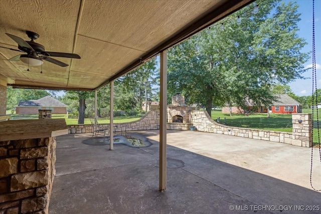 211 Meadowlark, Durant, OK 74701 - view of patio / terrace featuring an outdoor stone fireplace and a ceiling fan