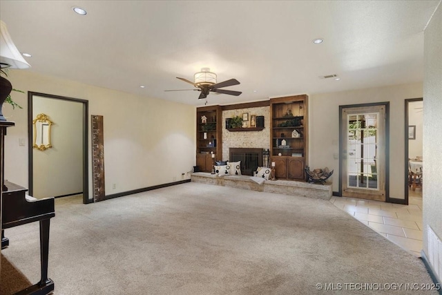211 Meadowlark, Durant, OK 74701 - unfurnished living room with carpet flooring, ceiling fan, a large fireplace, recessed lighting, and tile patterned floors