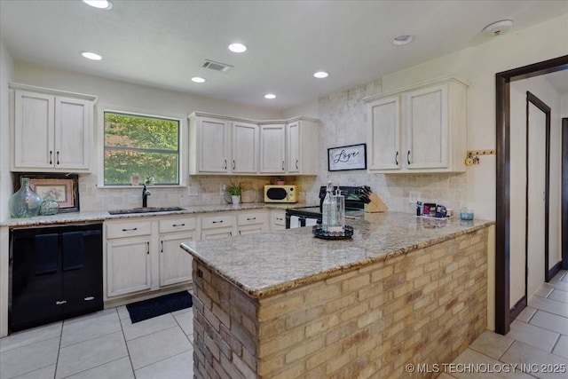 211 Meadowlark, Durant, OK 74701 - kitchen with white microwave, black dishwasher, a sink, light tile patterned flooring, and white cabinetry