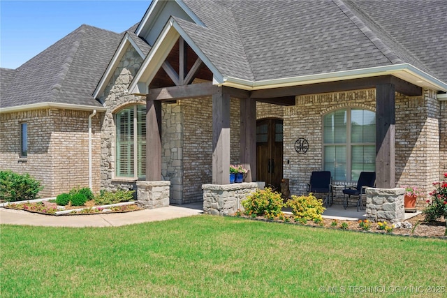 1580 Dawson Dr, Fort Gibson, OK 74434 - view of exterior entry featuring a lawn, brick siding, a shingled roof, and a porch