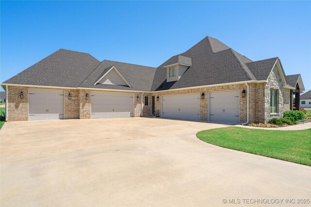 1580 Dawson Dr, Fort Gibson, OK 74434 - view of front of property with brick siding, a garage, driveway, and roof with shingles