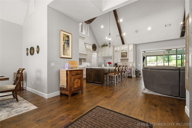 1580 Dawson Dr, Fort Gibson, OK 74434 - kitchen with light countertops, high vaulted ceiling, dark wood-style floors, a kitchen breakfast bar, and white cabinets