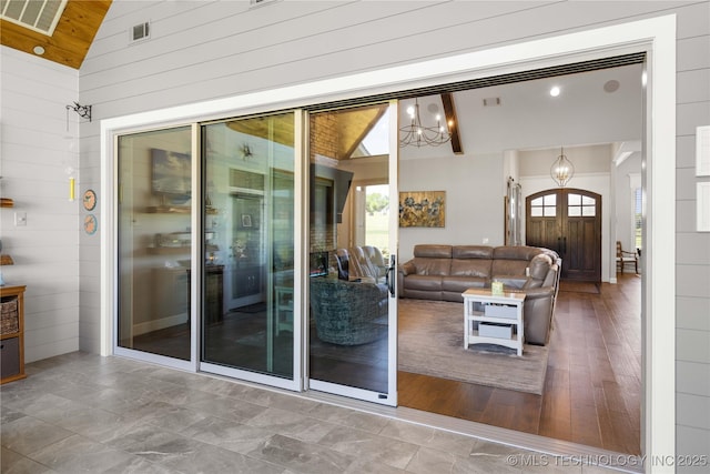 1580 Dawson Dr, Fort Gibson, OK 74434 - living area with a chandelier, healthy amount of natural light, wooden walls, high vaulted ceiling, and french doors