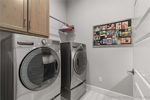 1580 Dawson Dr, Fort Gibson, OK 74434 - washroom featuring washer and dryer, cabinet space, and baseboards